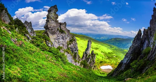 Clouds over the Gadzhin rock in the Carpathians. The famous place of power in the mountains, rocky outcrops above the glacial valley, below the snow from winter. photo