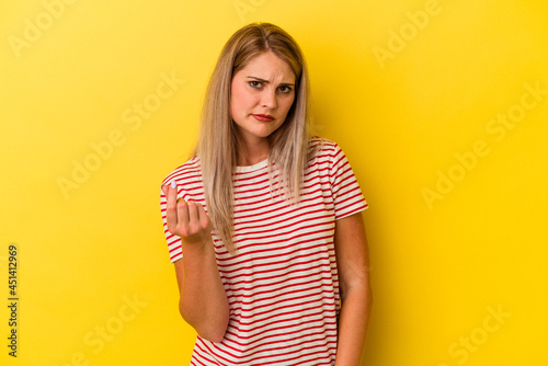 Young russian woman isolated on yellow background showing that she has no money.