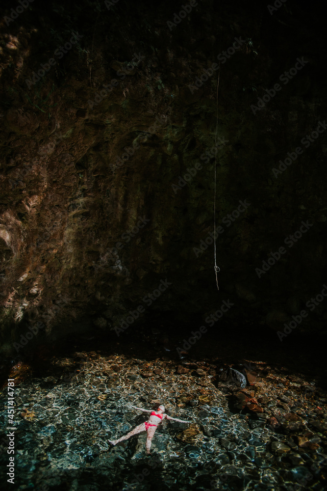 Woman relaxing in natural pool Woman relaxing in natural pool