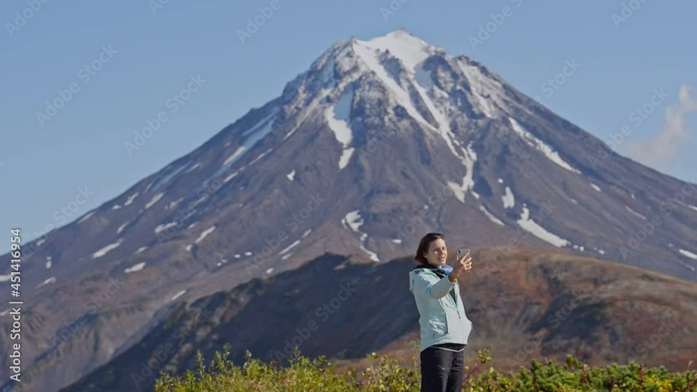 Hiking and eco tourism woman blogger against large mountain Hiking and eco tourism woman blogger against large mountain
