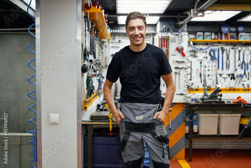 Cheerful man in bicycle repair workshop photo