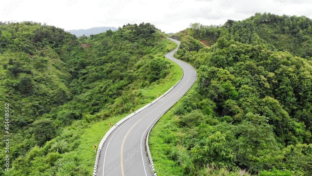 Asphalt highway through on top of valley with tropical rainforest Asphalt highway through on top of valley with tropical rainforest