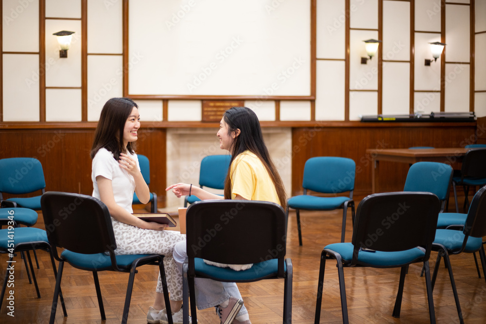 happy, cheerful, stylish Female university students chat with each other during small group discussion