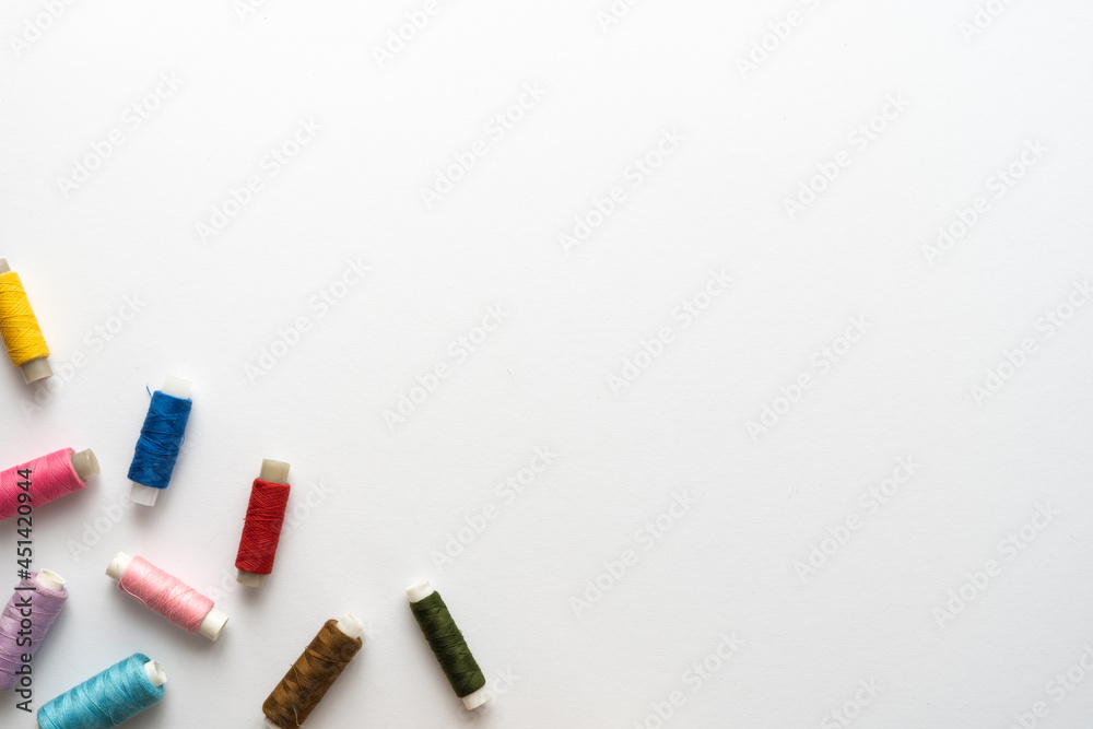Flat lay composition with sewing thread on white background. Space for text Flat lay composition with sewing thread on white background. Space for text