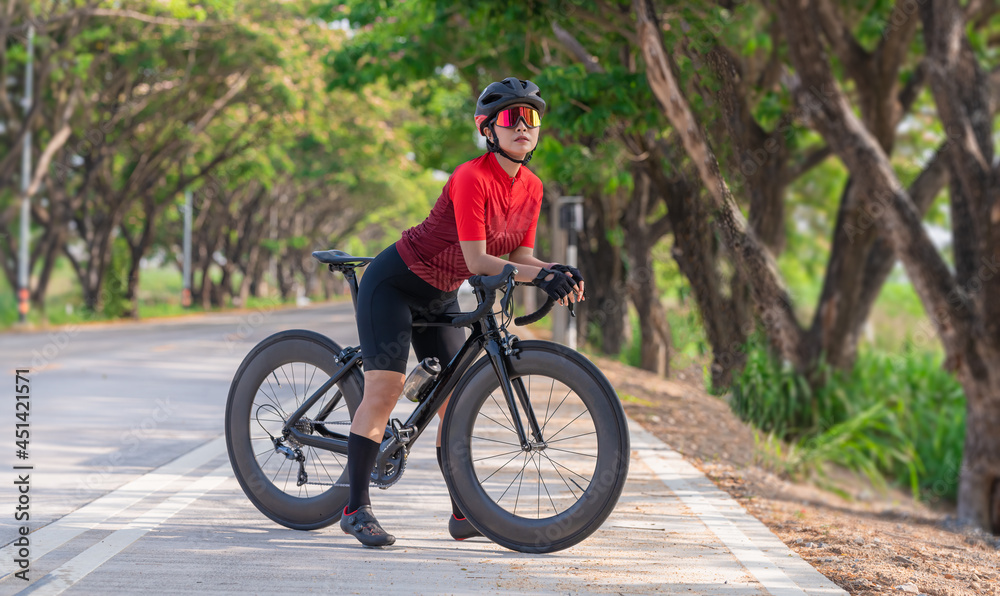 Portrait sport woman wearing sport suite helmet,glove and glasses,she competition on  bicycle bike is adventure and extream game concept.