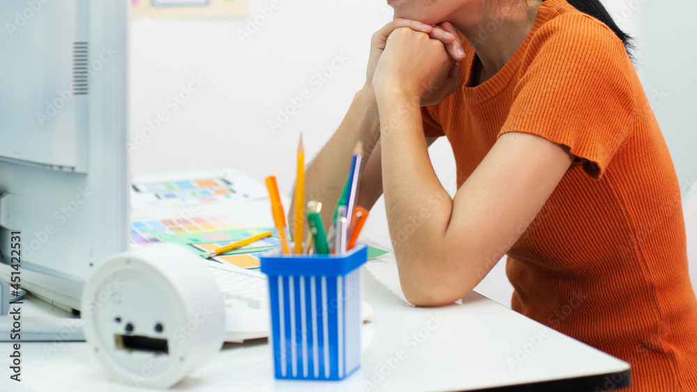 Woman working on computer on desk in office. Designers look at computer screens while working in the office. Woman working on computer on desk in office. Designers look at computer screens while working in the office.