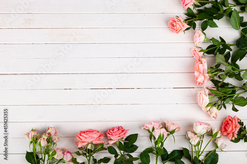 Fototapeta Naklejka Na Ścianę i Meble -  Border of pink roses on a  wooden background,