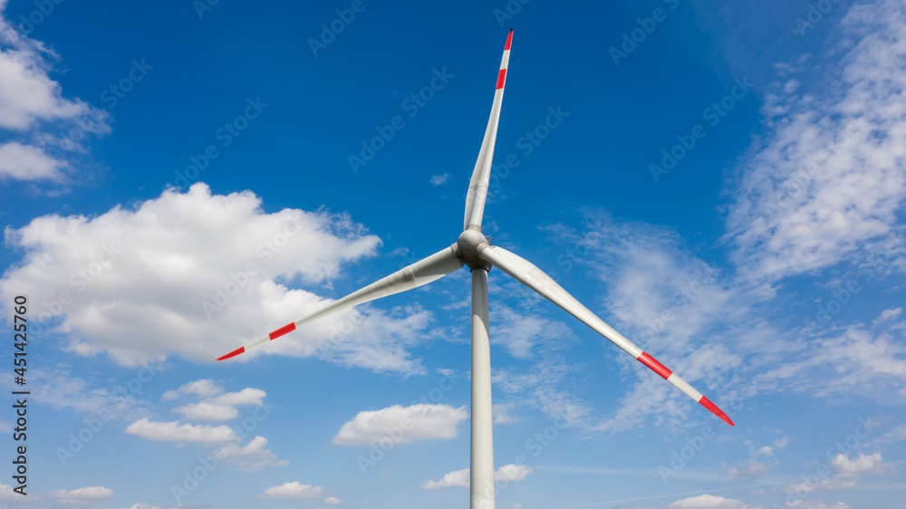 Aerial view of wind turbine windmill closeup against the sky with clouds. Alternative ecological energy production in Germany. Change climate concept. Aerial view of wind turbine windmill closeup against the sky with clouds. Alternative ecological energy production in Germany. Change climate concept.