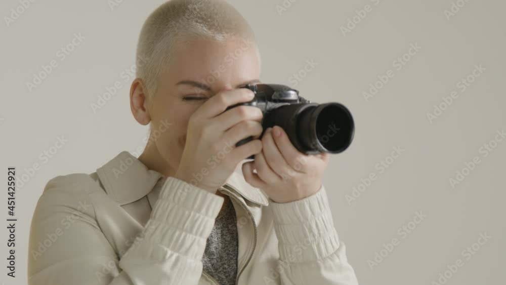 Young woman using a digital camera against white background 02 Young woman using a digital camera against white background 02