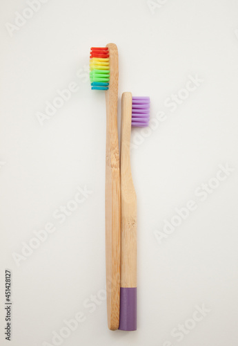 Bamboo toothbrushes on a white background. Colored bristles