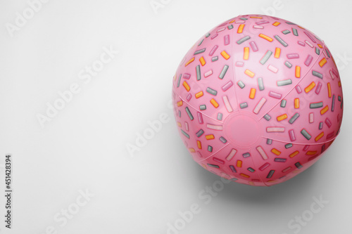 Pink beach ball on white background, top view. Space for text
