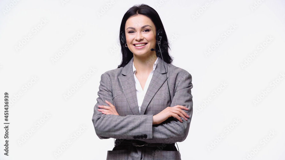 Smiling businesswoman in headset standing with crossed arms isolated on white. Smiling businesswoman in headset standing with crossed arms isolated on white.