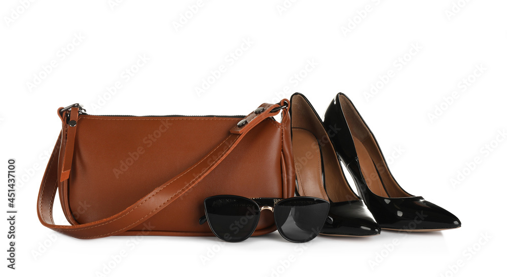 Brown women's mini bag, shoes and sunglasses on white background Brown women's mini bag, shoes and sunglasses on white background