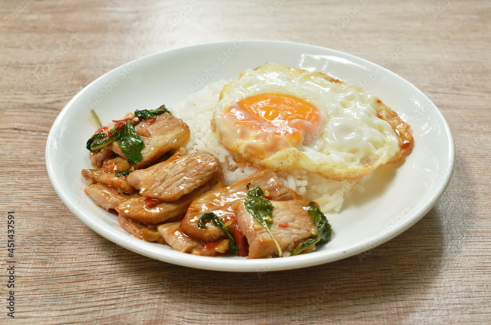 spicy stir fried slice grilled pork with chili and basil leaf topping egg on dish spicy stir fried slice grilled pork with chili and basil leaf topping egg on dish