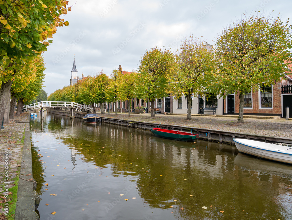 Canal and houses on Heerenwal quay in city of Sloten, Sleat, Friesland, Netherlands Canal and houses on Heerenwal quay in city of Sloten, Sleat, Friesland, Netherlands