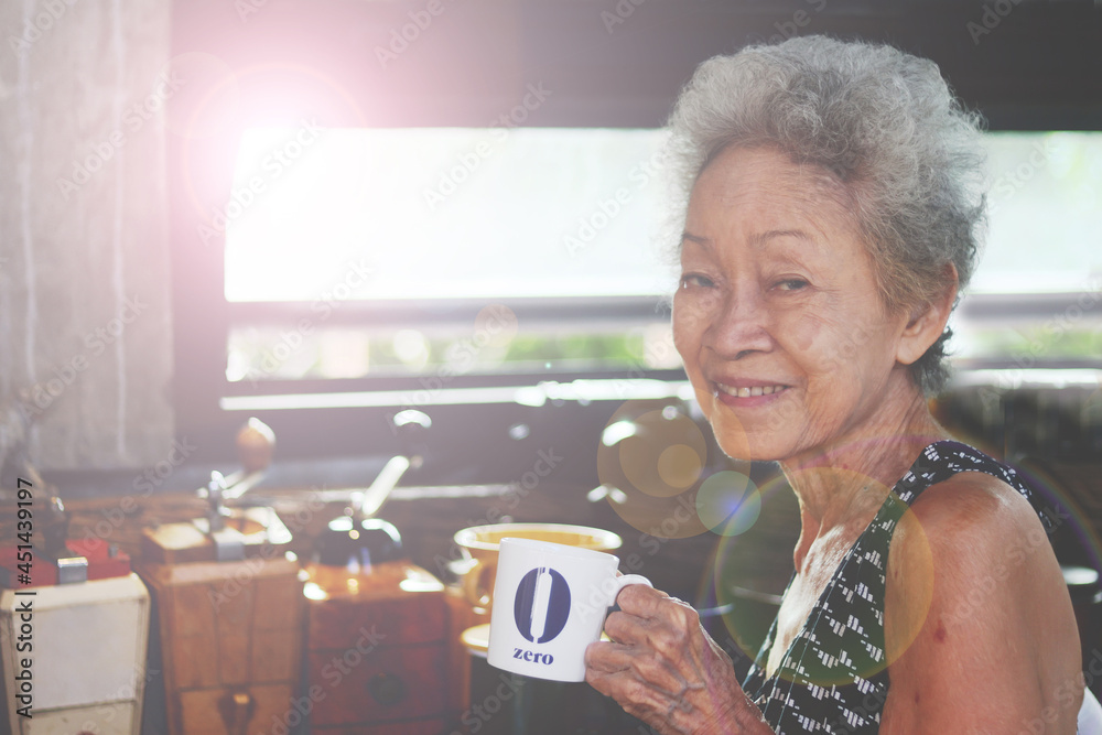Portrait of Asian Senior retirement woman smile with casual clothing in home happy lifestyle. Elderly Grandma. Southeast Asia Ethnicity Good Healthy.Coffee cup equipment retro style copy space. Portrait of Asian Senior retirement woman smile with casual clothing in home happy lifestyle. Elderly Grandma. Southeast Asia Ethnicity Good Healthy.Coffee cup equipment retro style copy space.