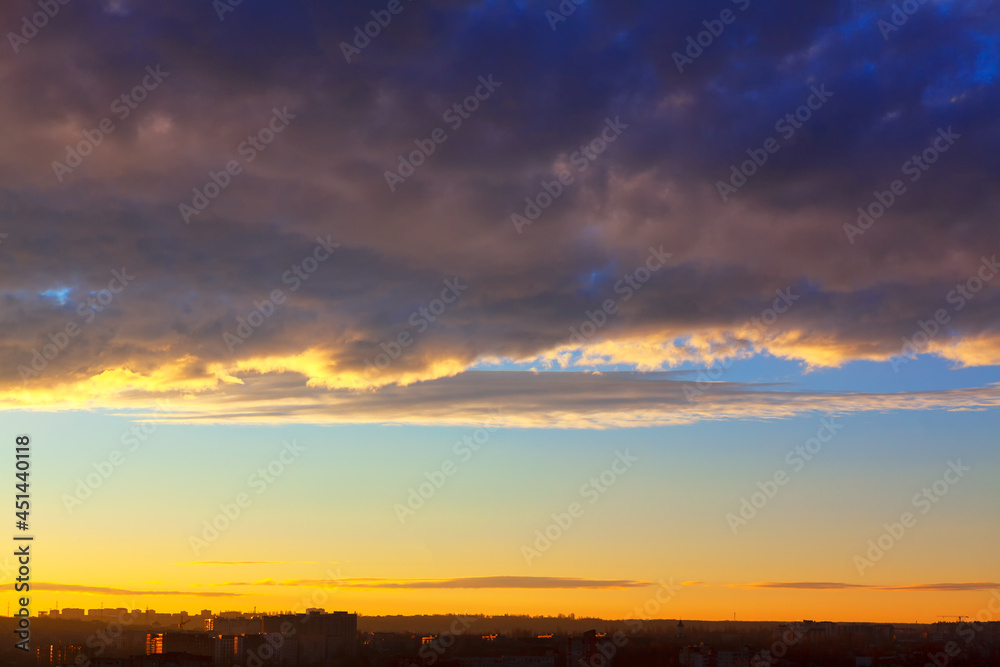 Evening clouds over the city . Cloudscape over the horizon in the twilight