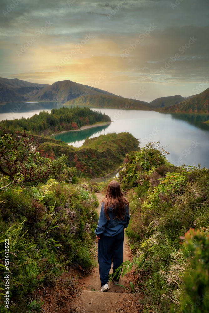 Woman walking towards Lagoa do Fogo Crater Lake on Sao Miguel, Azores