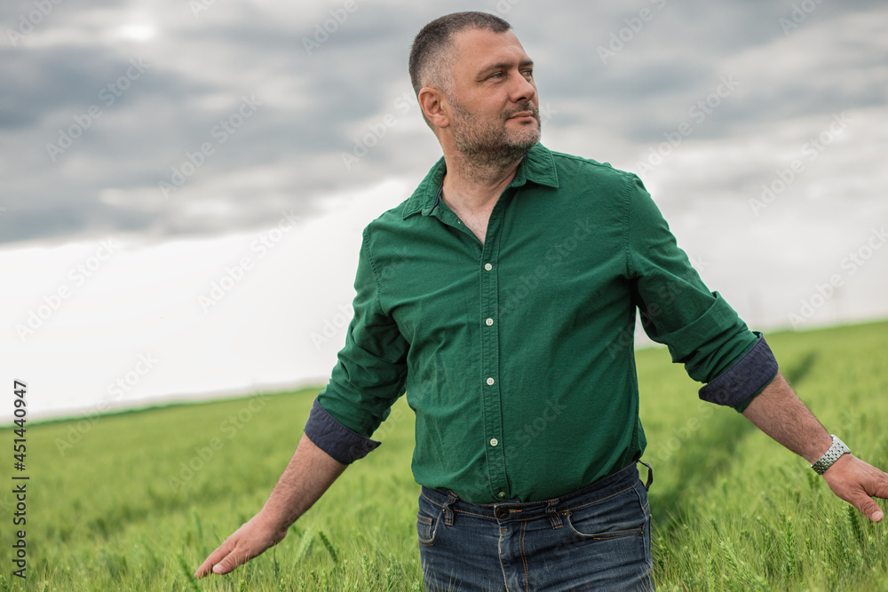 Portrait of farmer standing in wheat field. Portrait of farmer standing in wheat field.