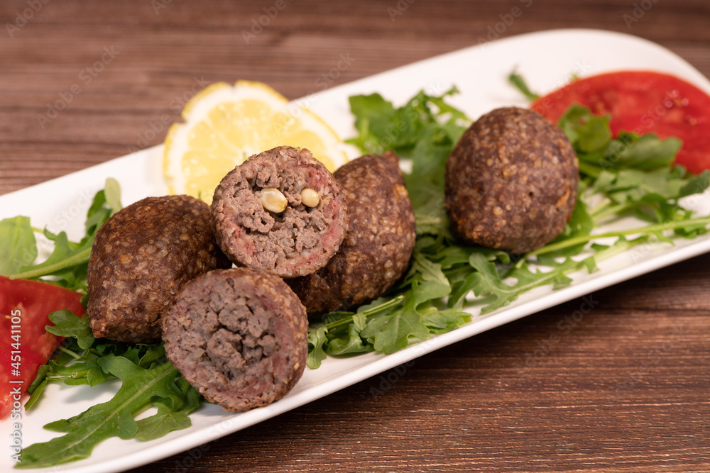 Traditional kebbe and pita bread on big round plate in lebanese restaurant. High quality photo Traditional kebbe and pita bread on big round plate in lebanese restaurant. High quality photo