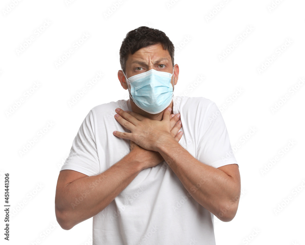 Man in medical mask suffering from pain during breathing on white background Man in medical mask suffering from pain during breathing on white background