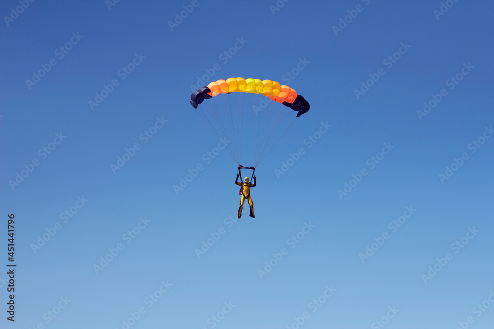 Flight of an experienced paratrooper with a professional parachute in the sky Flight of an experienced paratrooper with a professional parachute in the sky