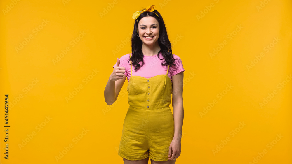 Young smiling woman showing like isolated on yellow. Young smiling woman showing like isolated on yellow.