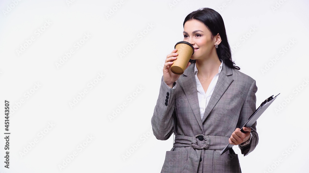 Businesswoman in jacket drinking coffee to go and holding clipboard isolated on white. Businesswoman in jacket drinking coffee to go and holding clipboard isolated on white.