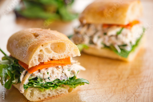 Chicken sandwiches. Served on toasted whole grain bread with melted Swiss cheese, mayonnaise and seasoned salt and pepper.  Classic American restaurant or diner lunch or brunch sandwich favorite.