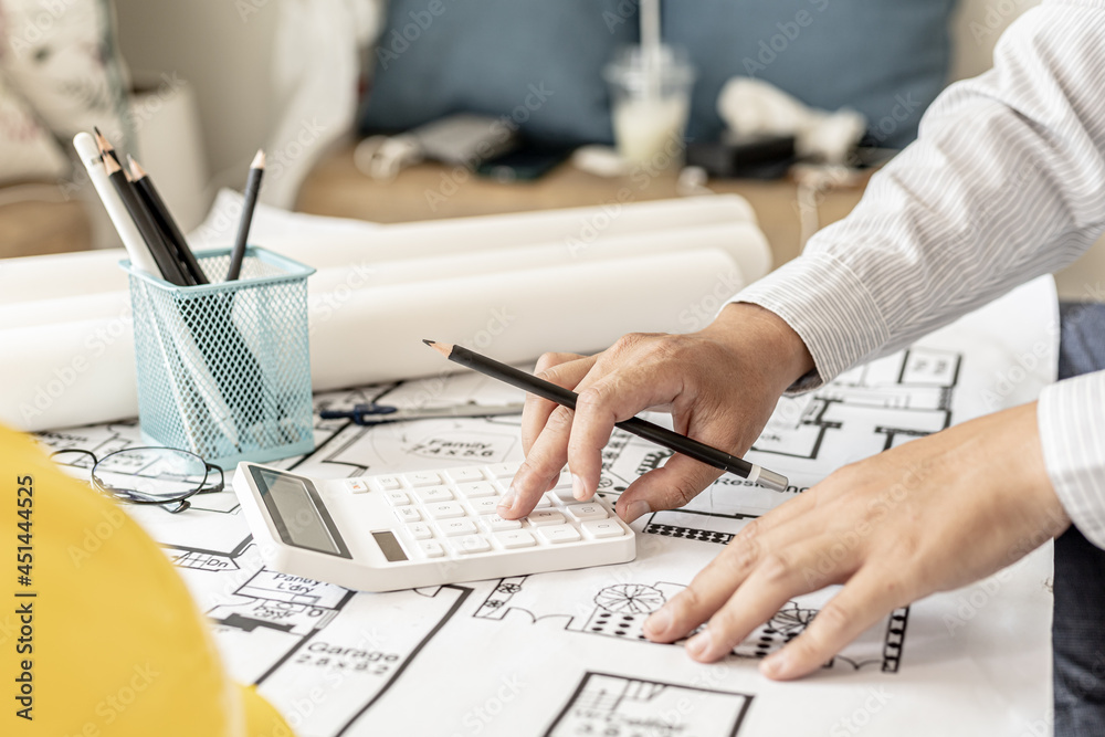The architects pressed a calculator to calculate the area in a ...