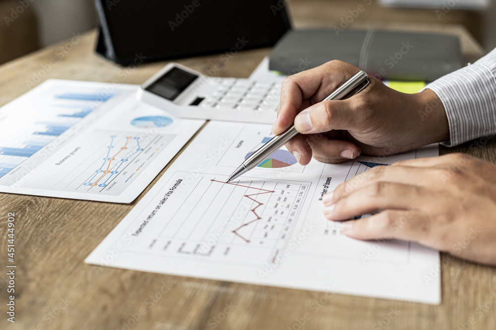Financial scholars are looking at numbers on financial documents to verify the accuracy of company financial data, financial status documents line and pie charts. Finance concept. Financial scholars are looking at numbers on financial documents to verify the accuracy of company financial data, financial status documents line and pie charts. Finance concept.