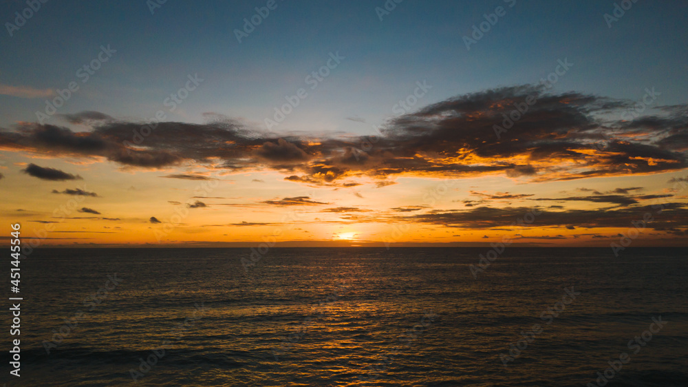 Fototapeta premium Dramatic yellow sundown and amazing view sea.Beautiful smooth waves and beautiful cloud in sky.