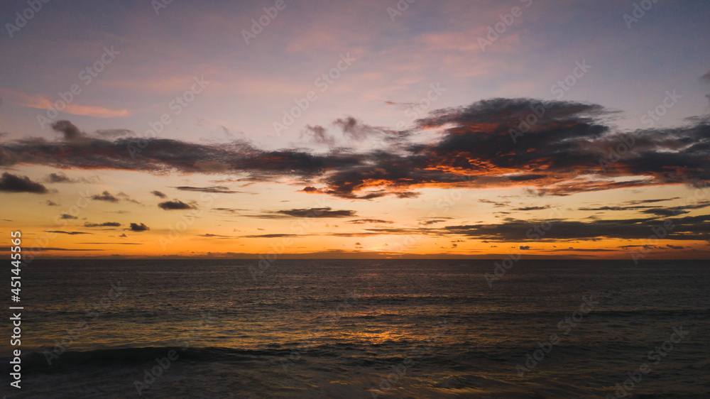 Amazing Orange color sunset sky and ocean waves crashing on beach.Landscape Aerial view backgrounds