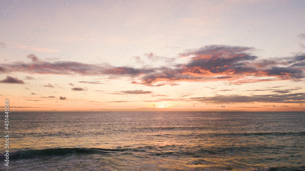 Beautiful sunset over the beach.tropical sundown over the sea cloud and waves golden beach.