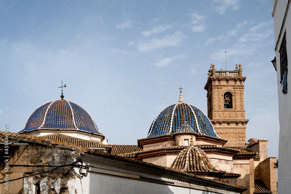 The main church 'San Roque' with blue tiled domes and tower from the 18th century in Oliva, Spain