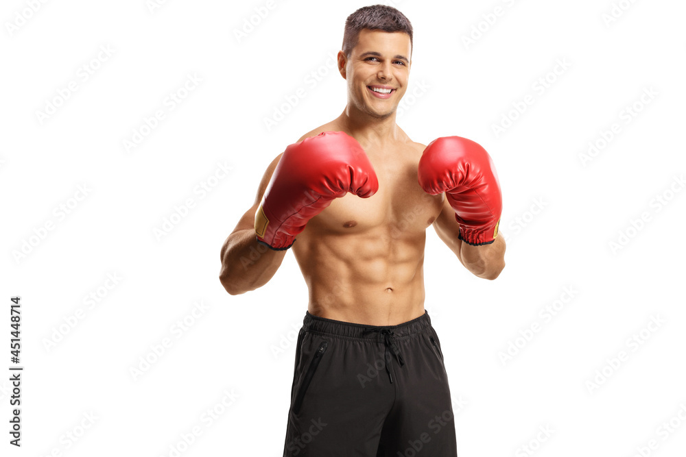 Smiling boxer posing shirtless in black shorts and red gloves Smiling boxer posing shirtless in black shorts and red gloves