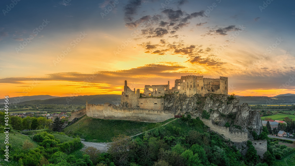 the ruins of Beckov Castle in the light of the setting sun