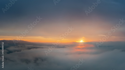 sunrise high above the clouds with the sun