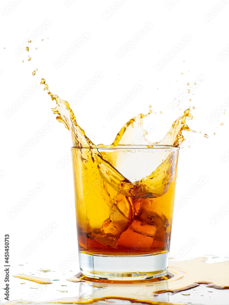 splash from falling ice glass with whiskey on white background splash from falling ice glass with whiskey on white background