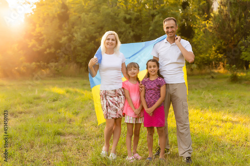 happy family with flag of ukraine in field. lifestyle