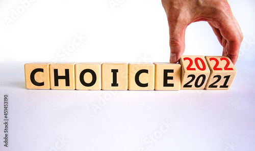 Planning 2022 choice new year symbol. Businessman turns wooden cubes and changes words 'choice 2021' to 'choice 2022'. Beautiful white background, copy space. Business, 2022 choice new year concept.