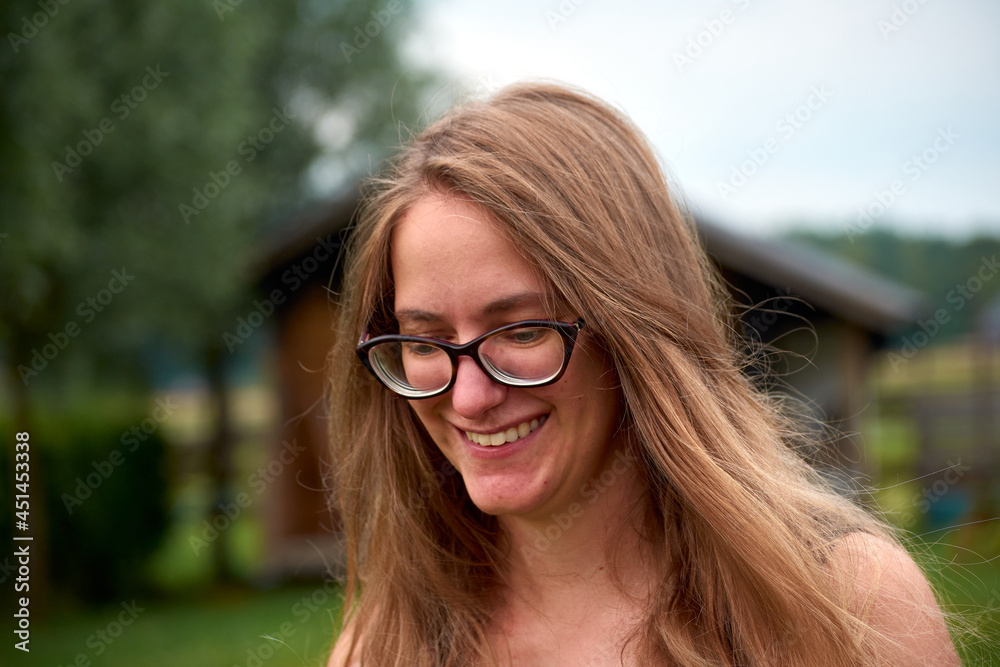 A closeup of a beautiful smiling woman with blond long hair A closeup of a beautiful smiling woman with blond long hair