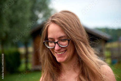 A closeup of a beautiful smiling woman with blond long hair