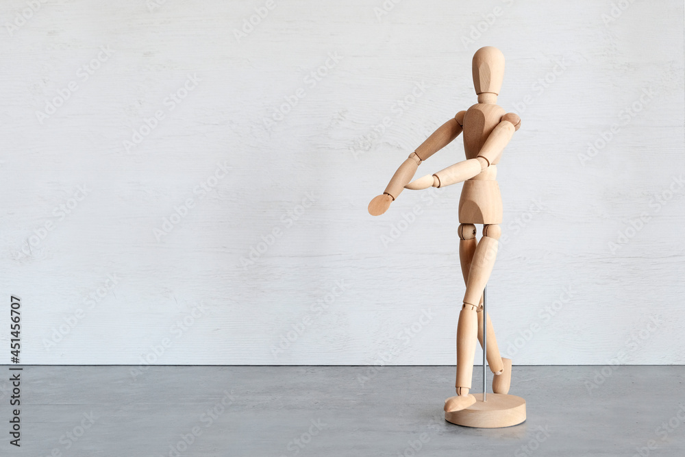 Wooden mannequin on a gray background. Copy space Wooden mannequin on a gray background. Copy space