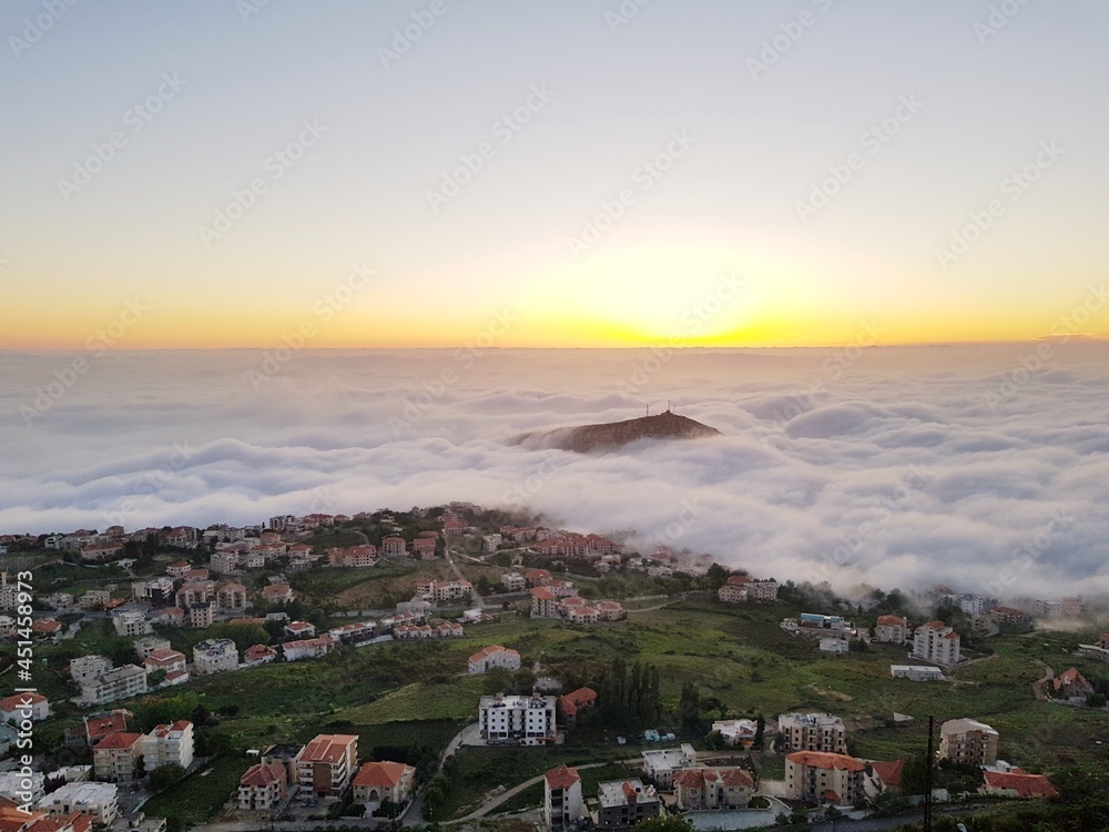 sunset over the clouds in the mountain