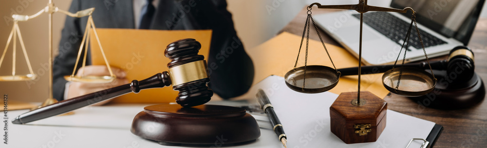 Business and lawyers discussing contract papers with brass scale on desk in office. Law, legal services, advice, justice and law concept picture with film grain effect