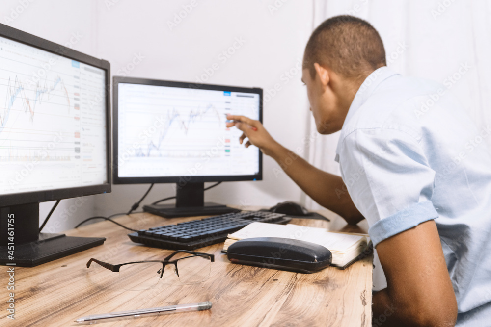 a person looking at some graphs on his screen. technology concept and trading classes.