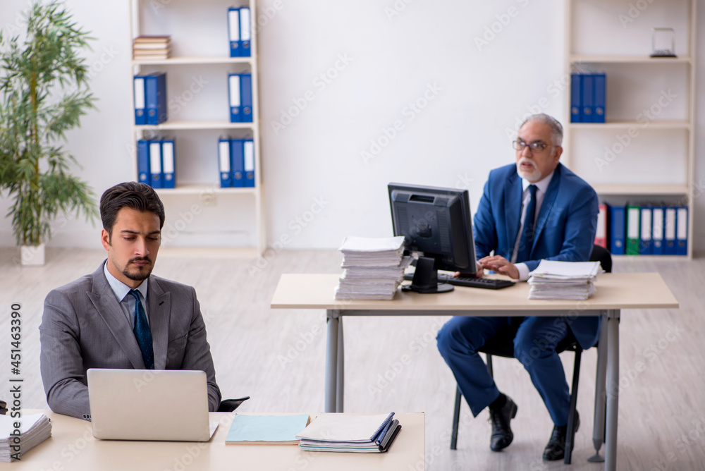 Two male colleagues working in the office