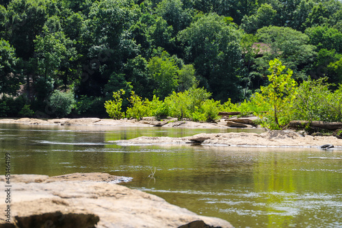 a gorgeous shot of the rushing waters of the Chattahoochee river with lush green trees reflecting off the water at McIntosh Reserve Park in Whitesburg Georgia photo