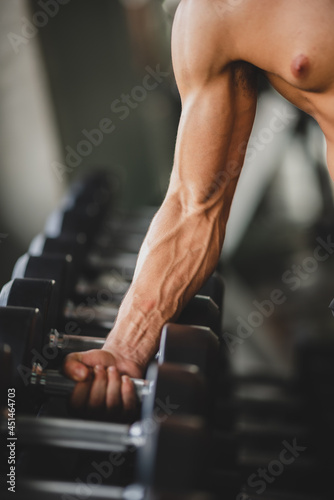 strong man exercising in the sport gym, workout exercise training in fitness for body strong and fit, healthy lifestyle athlete man active people, strength power of muscular bodybuilding weight